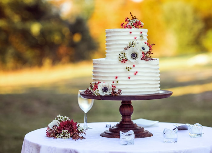 Ivory tiered wedding cake decorated with roses