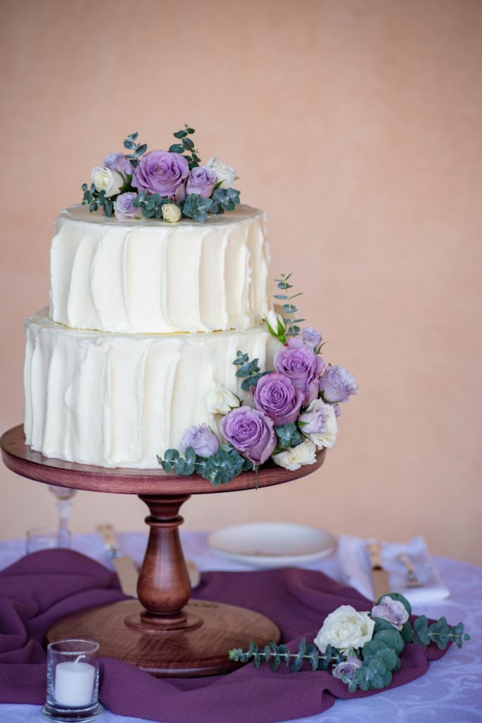 Wedding cake surrounded by pink roses