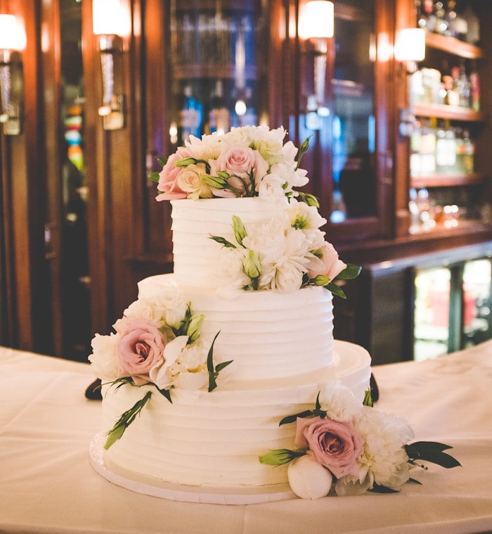 Three-tier white fondant wedding cake